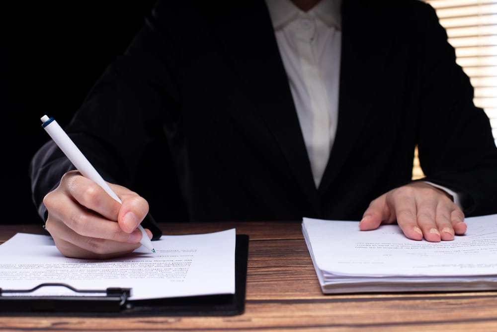 A car accident lawyer discussing paperwork with a client after a crash.