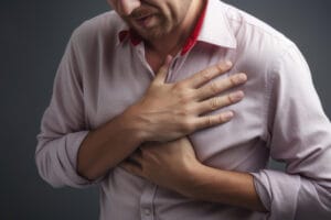 Man holding his chest in pain after a car accident.