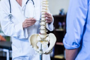 Showing post-operative spinal fusion with metal implants