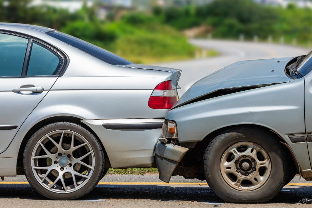 Rear-end collision with damaged vehicles on a city street