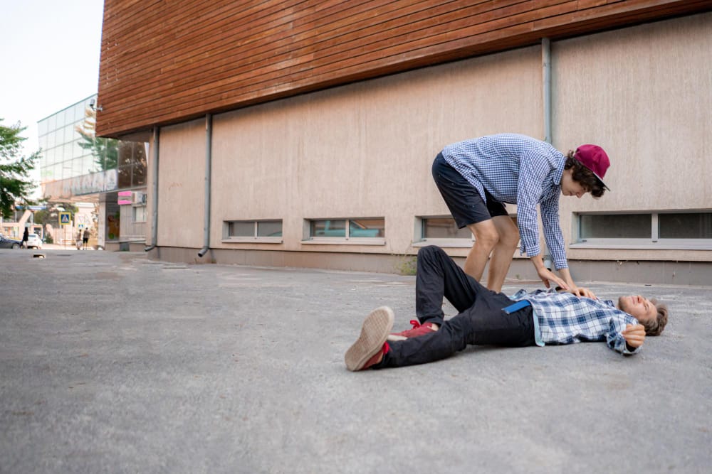A man slips and falls on a wet floor inside a building, highlighting premises liability.