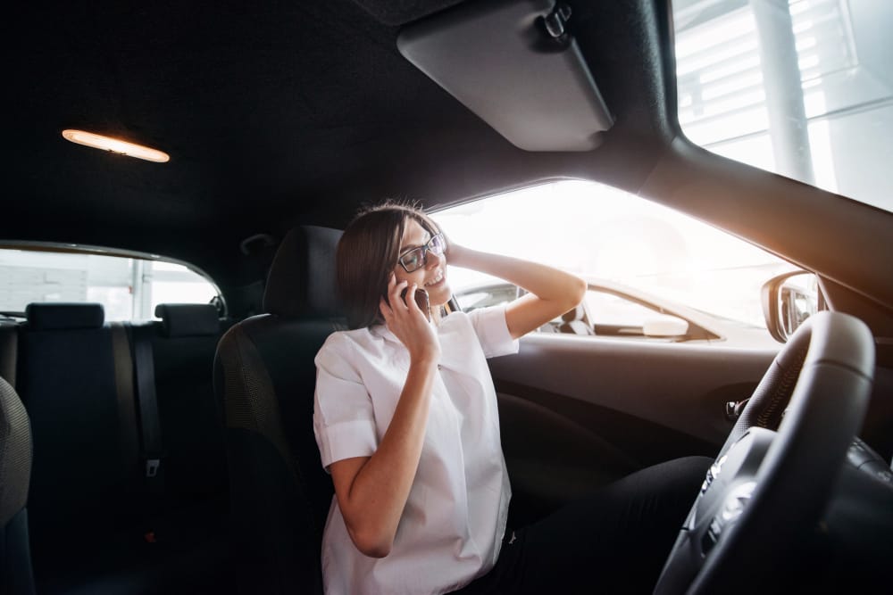 Types Of Distracted Driving A driver using a smartphone while driving, highlighting the dangers of distracted driving.