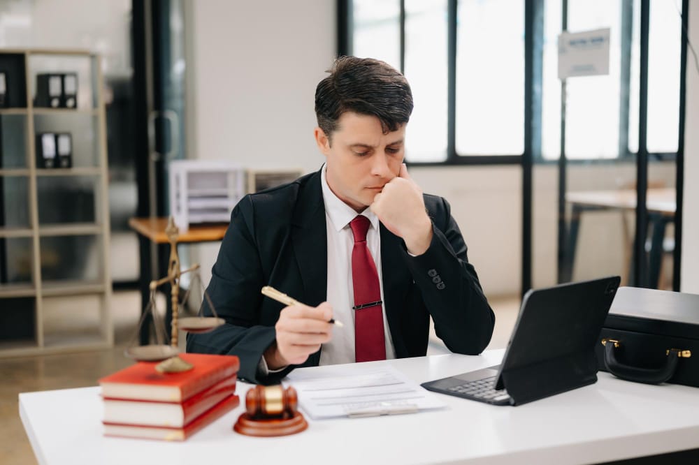 A person consulting with a workers' compensation attorney, discussing important questions.