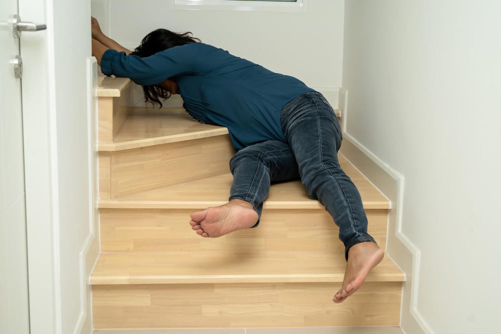 A woman lying on the ground after a stair accident in Chicago.