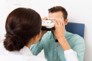 An ophthalmologist examining a patient's eye.