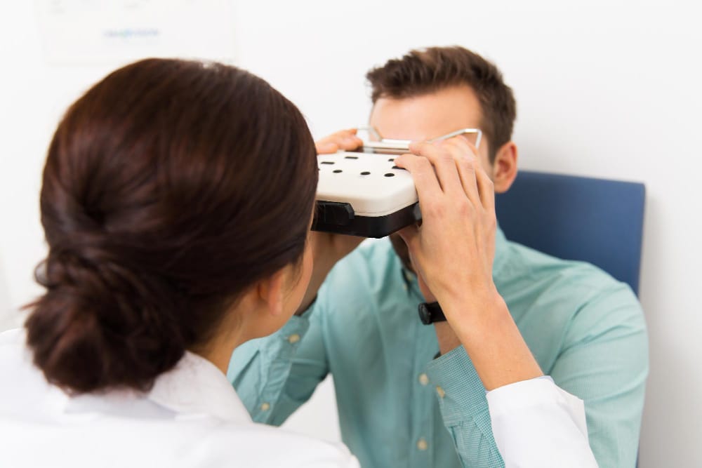 An ophthalmologist examining a patient's eye.