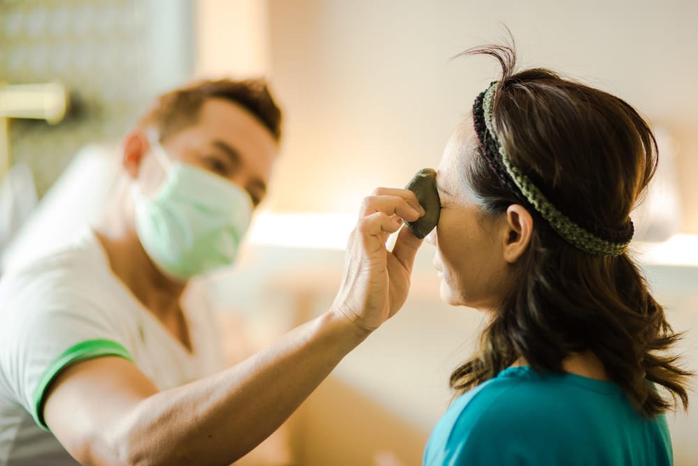 An ophthalmologist examining a patient's eye.
