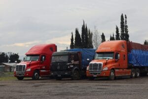 Fleet of trucks parked at a trucking company yard - shell companies and liability investigation