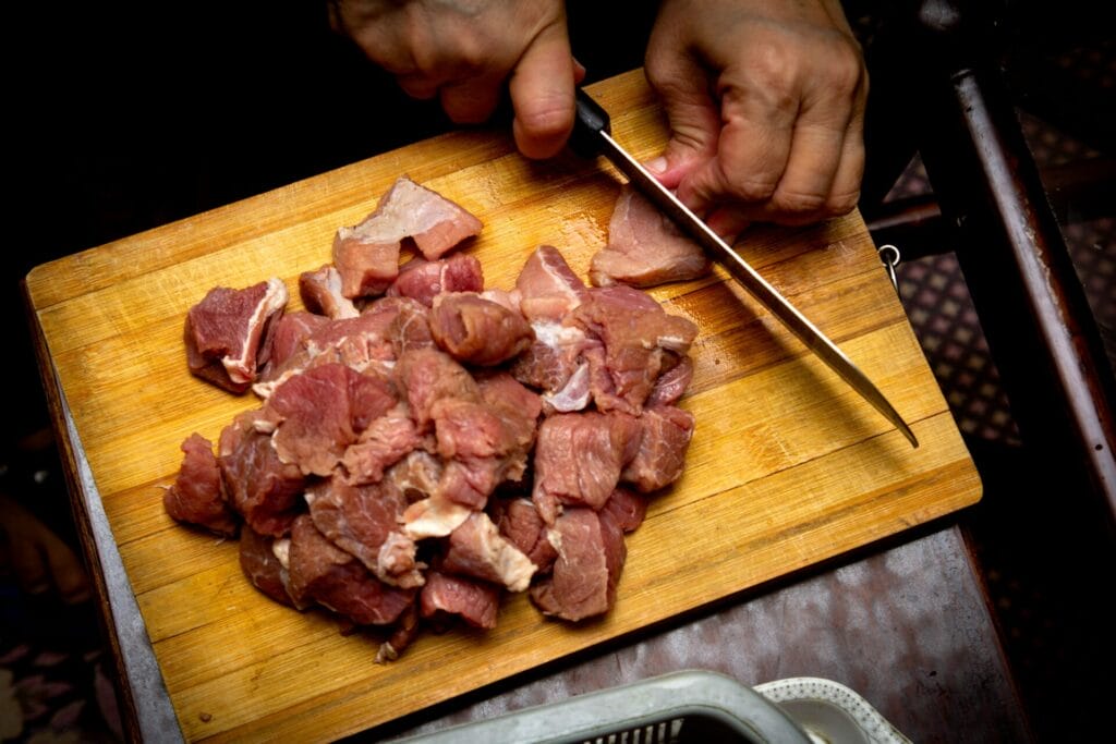 Raw meat on a cutting board illustrating cross-contamination risk