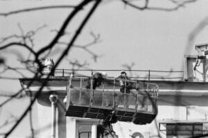 Workers in an aerial lift illustrating equipment failure liability